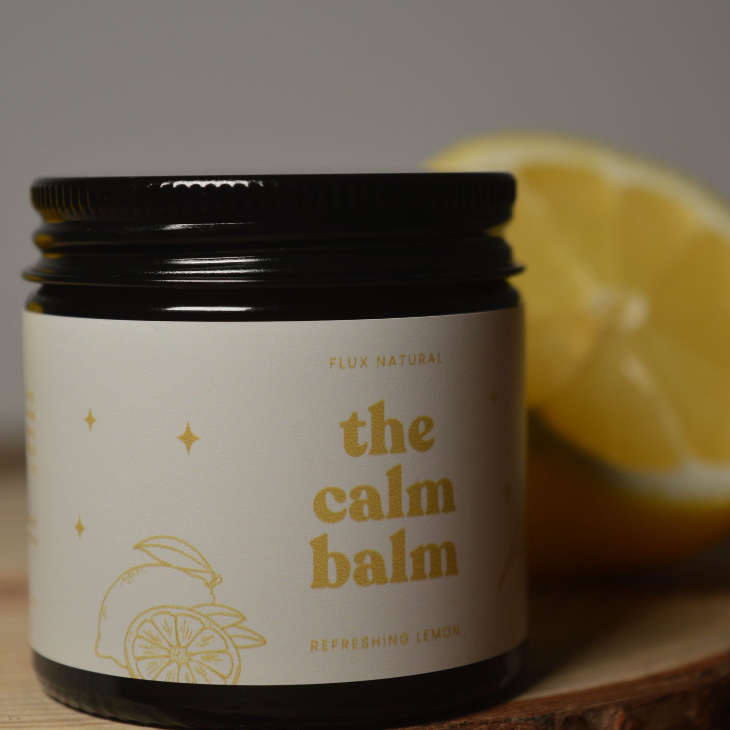 Jar of 'the calm balm' with a lemon in the background
